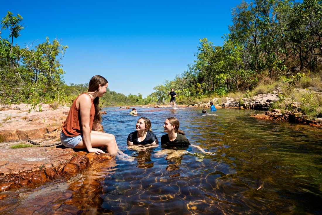 Kids cooling off during a walk in Kakadu National Park |  Tourism NT/Shaana McNaught